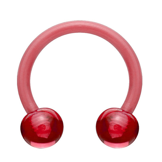 An acrylic horseshoe red earring with a ball on each end pictured against a white background.