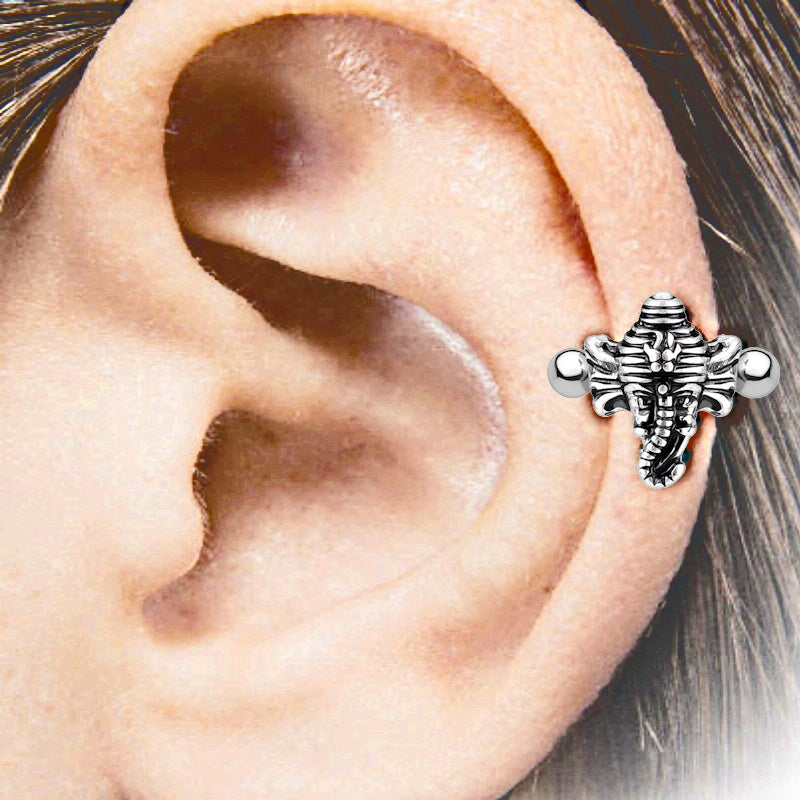 An antique silver elephant earring cuff pictured on the ear of a model.