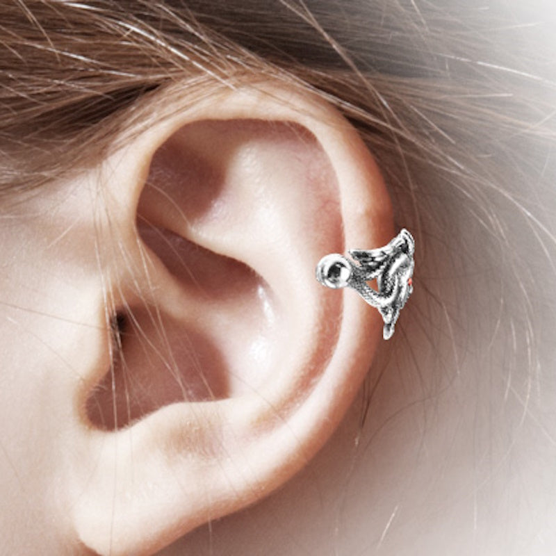 An antique silver Medusa earring cuff pictured on the ear of a model.