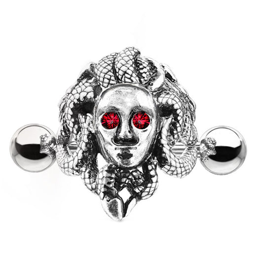 An antique silver Medusa earring cuff pictured against a white background.