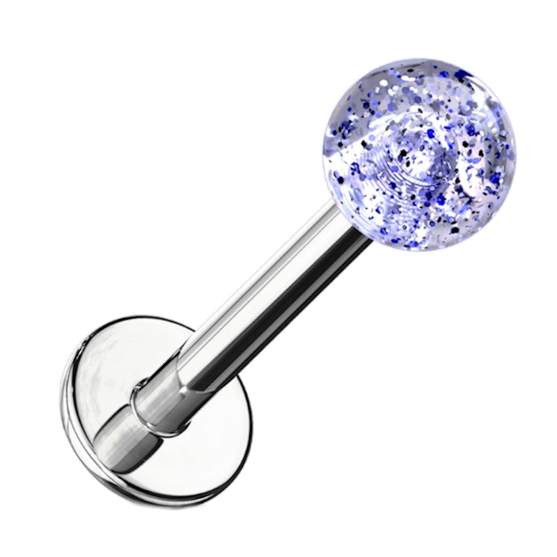 A blue glitter labret earring pictured against a white background.