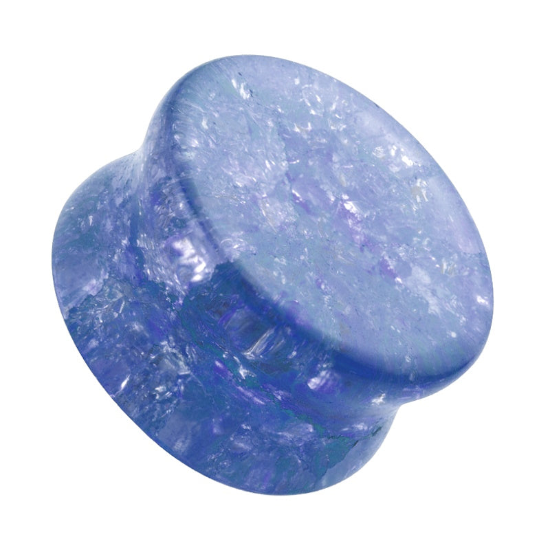 One of a pair of blue shattered glass plugs pictured against a white background.