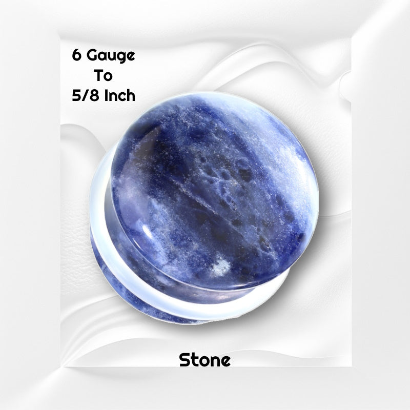 One gauge of a pair of blue sodalite stone gauges pictured on a white wavy background with black text stating the sizes available of this plug earring.