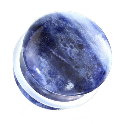 One of a pair of blue sodalite stone gauges with a clear O-ring pictured against a white background.