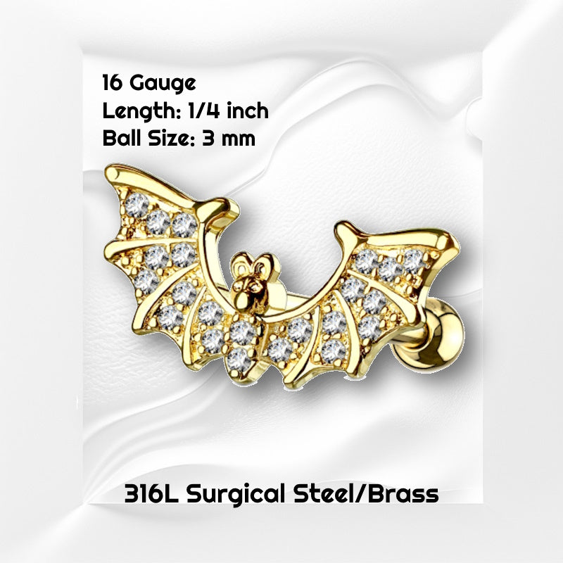 A gold plated bat earring with paved cubic zirconia wings pictured against a white wavy background with black text stating the size of this earring.