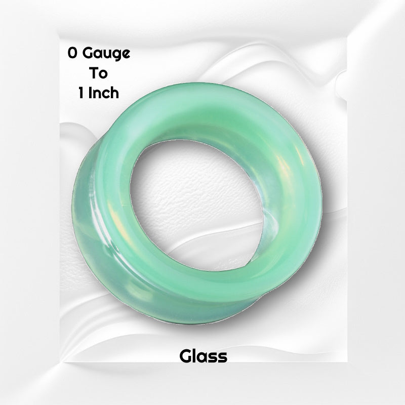 One of a pair of green opalite glass tunnels pictured against a white wavy background with black text stating the sizes available of this tunnel earring.