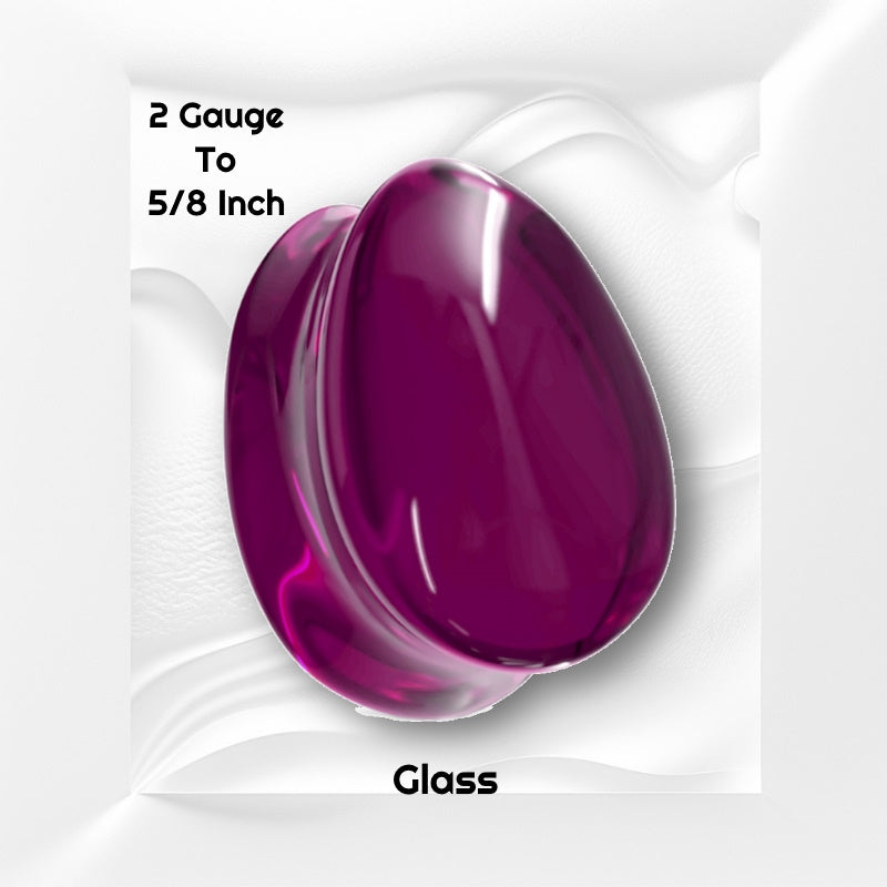 One of a pair of purple glass teardrop gauges pictured on a white wavy background with black text stating the sizes available of this gauge earring.