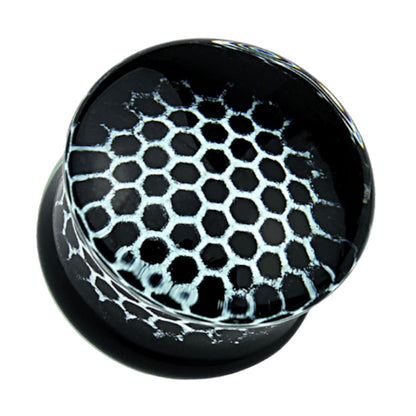 One of a pair of Pyrex glass honeycomb gauges with a white honeycomb design on a black background pictured against a white background.