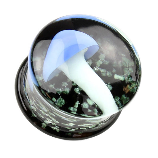 One of a pair of pyrex glass mushroom gauges with a blue top mushroom and a white stem all with a black background that has glow in the dark sparkles pictured against a white background.