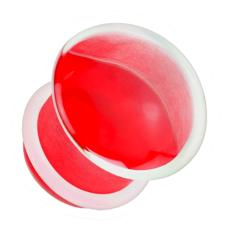 One of a pair of red glass ear gauges with a clear silicone o-ring pictured against a white background.