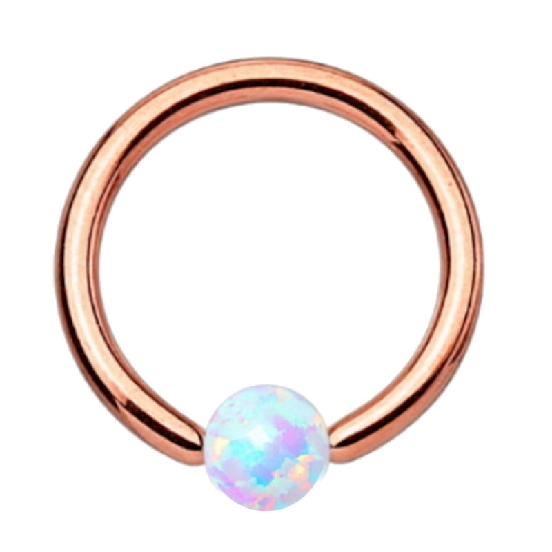 A rose gold opal earring pictured against a white background. 