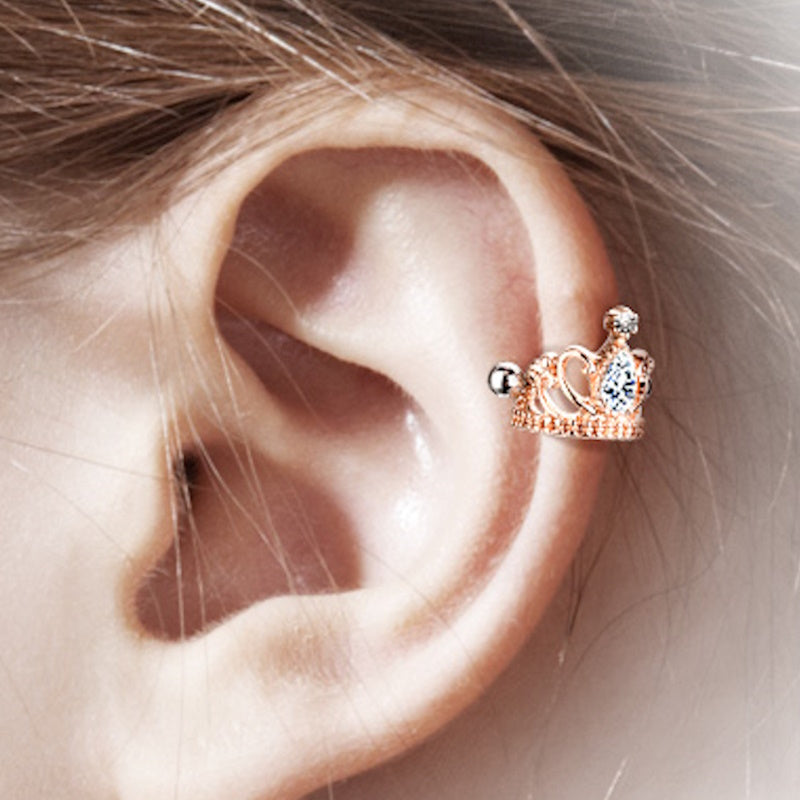 An rose gold tiara earring cuff pictured on the ear of a model.