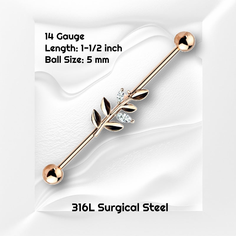 A rose gold vine industrial earring pictured on a white wavy background with black text stating the size available of this industrial barbell.