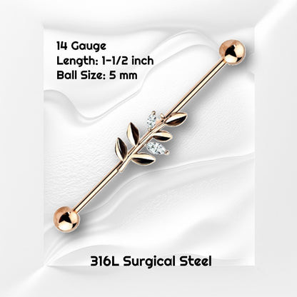 A rose gold vine industrial earring pictured on a white wavy background with black text stating the size available of this industrial barbell.