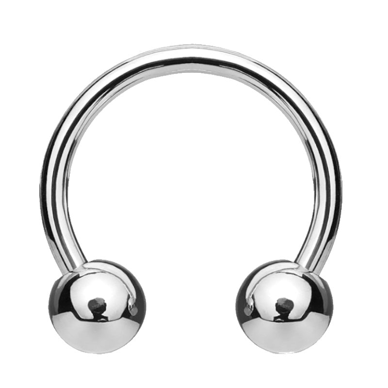 A surgical steel circular barbell earring with a horseshoe shaped design and a ball on each end pictured against a white background.