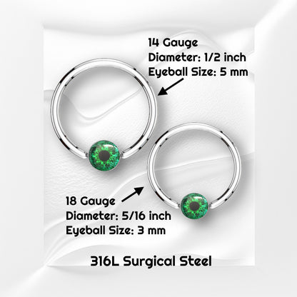 A surgical steel green eyeball earring featuring a captive green eyeball bead pictured against white wavy background with black text stating the size available of this horseshoe earring.