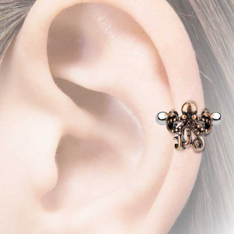 A surgical steel octopus earring cuff pictured on the ear of a model.