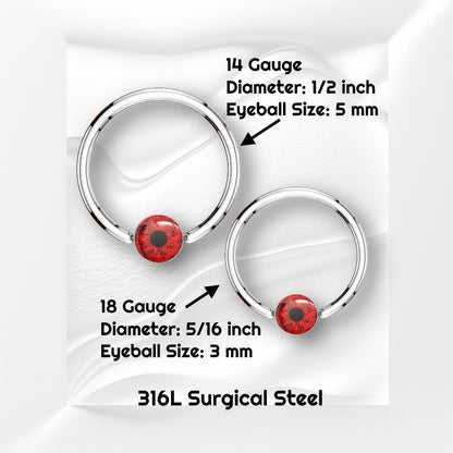 A surgical steel red eyeball earring featuring a captive red eyeball bead pictured against white wavy background with black text stating the size available of this horseshoe earring.