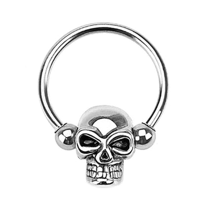 A surgical steel skull earring pictured against a white background.