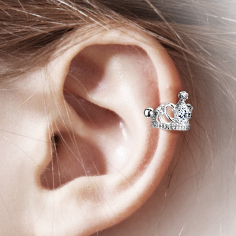 An surgical steel tiara earring cuff pictured on the ear of a model.