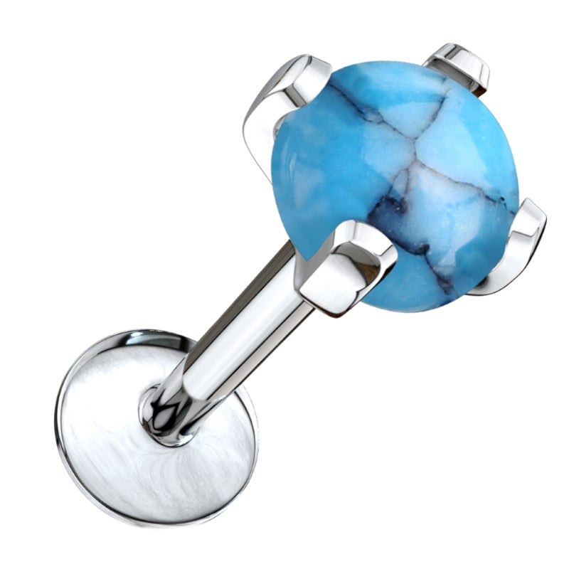 A turquoise stone labret earring on a surgical steel labret stud pictured diagonally against a white background.